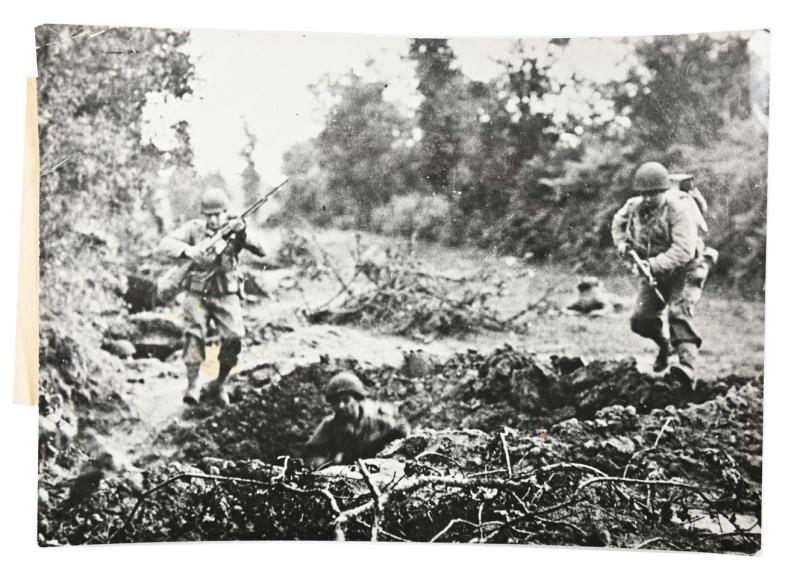 US WW2 Press Photo Normandy 'Americans Leap for Shell Hole in France'